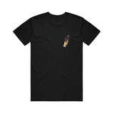image of a black tee shirt on a white background. the tee has a small print on the right chest of a tan hand holding a blue and red bird tied up in rope.