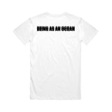 image of the back of a white tee shirt on a white background. the tee has a black print across the top shoulders in blurred text that says being as an ocean.