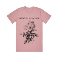 image of an orchid tee shirt on a white background. tee has full body print in black that says at the top, being as an ocean, with roses below