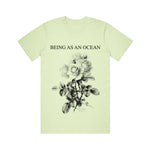 image of a spring green tee shirt on a white background. tee has full body print in black that says at the top, being as an ocean, with roses below