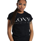 image of a black woman wearing a black tee shirt tee shirt on a white background. tee has a full chest print in white that says LOVE, being as an ocean