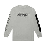 image of the front of an ash colored long sleeve tee on a white background. front of tee front of the long sleeve is on the left and has a center chest print that says being as an ocean. two sleeve prints on each sleeve