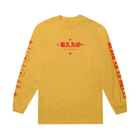 image of the front of a gold long sleeve tee shirt on a white background. long sleeve has a small center chest print in red of the letters B A A O. Each sleeve has a print. 
