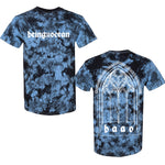 image of the front and back of a blue crystal wash tie dye tee shirt on a white background. front of the tee is on the left and has a white print across the chest that says being as an ocean. the back is on the right and has a full back print in white of an arched window with the letters B A O O at the bottom.