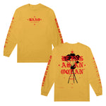 image of the front and back of a gold long sleeve tee shirt on a white background. front of the long sleeve is on the left and has a small center chest print in red of the letters B A A O. Each sleeve has a print. the back of the long sleeve is on the right and has a full back print of black roses and the words being as an ocean over the roses in red