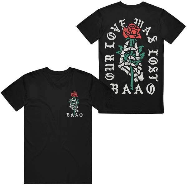 image of the front and back of a black tee shirt on a white background. the front of the the tee is on the left and has a small chest print on the right of a skeleton hand holding a red rose with the letters B A O O below. the back of the tee is on the right and has a full back print of a skeleton hand holding a red rose with the words our love was lost arched around and the letters B A O O at the bottom.