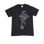 image of a black tee shirt on a white background. tee has full body print in white that says on the right vertically being as an ocean with a hand holding flowers on the right.